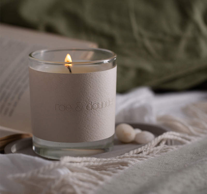 Unscented candle alight on a tray