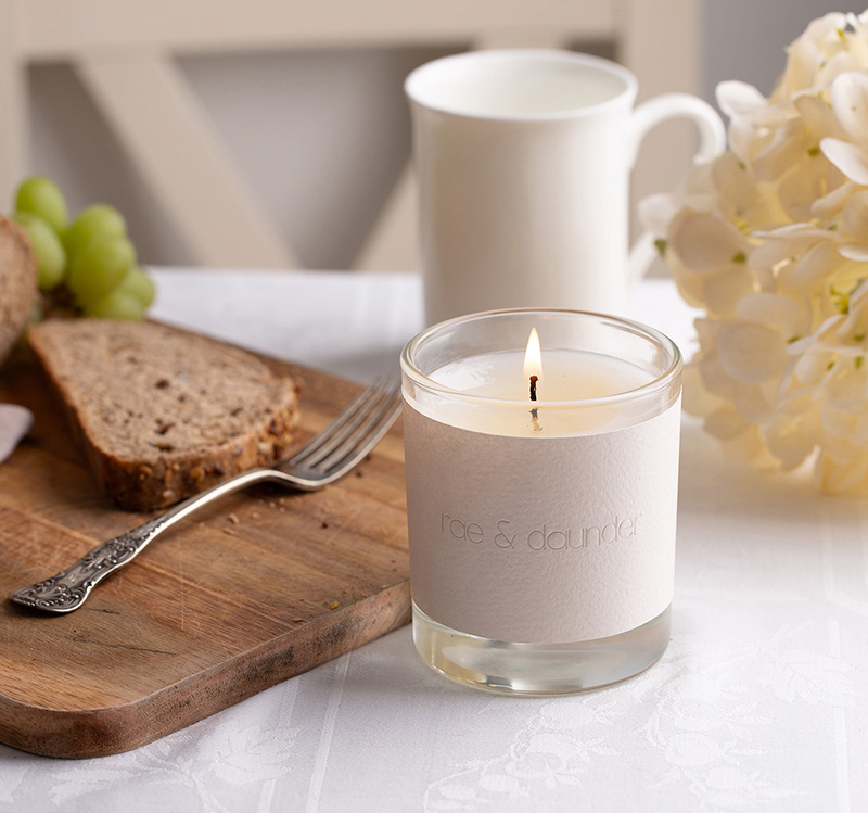 Pear candle next to grapes and bread
