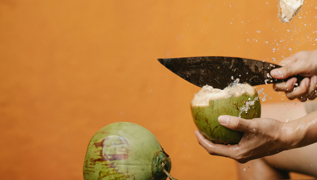 knife chopping a coconut, why blending coconut and beeswax makes a better candle