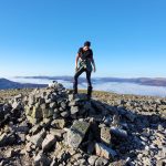 Woman on top of mountain. The power of nature and the healing touch of candles