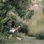 Woman enjoying forest bathing with a hot drink