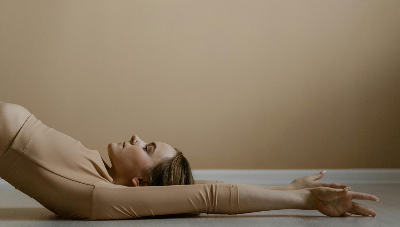 Gentle yoga practice by candlelight as part of calming summer rituals