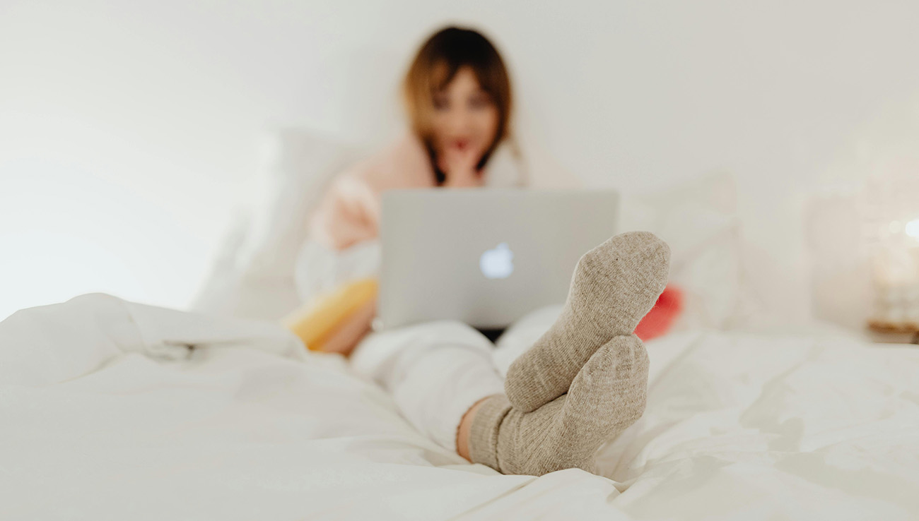 Relaxing in bed with a laptop and candlelight on a September evening.