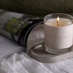 lit rae and daunder candle on a tray symbolising warmth, rest, and gentle living with chronic illness